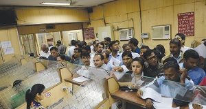 People queue inside a bank as they deposit and exchange 500 and 1000 currency notes, in New Delhi on November 10, 2016. Customer-facing roles in myriad forms remain a mainstay in banking jobs. / AFP PHOTO / MONEY SHARMA